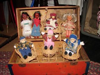 VINTAGE RED WOODEN TRUNK WITH SEVEN DOLLS SET OF WICKER FURNITURE