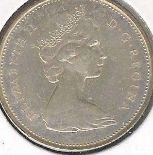 1967 CANADIAN SILVER 25 CENTS IN MS 64+ CONDITION WITH A LITTLE TONED 