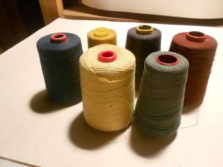 large vintage spools of thread   yellow, blue, burgandy