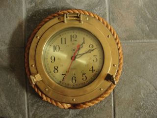   style battery operated wall clock, wood, old brass ship window, rope