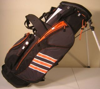 New adidas ADI Clutch Stand Bag Black/Grey/Ora​nge TaylorMade Golf