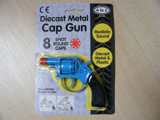   SMALL BLUE METAL TOY CAP GUN TAKES 8 SHOT RED PLASTIC RING CAPS