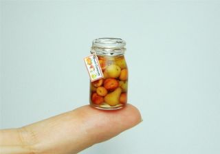 colorful jar containing apples pears nectarines and apricots so 