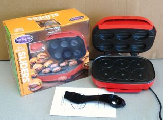 Up for an auction a NOSTALGIA ELECTRIC SLIDERS MINI BURGER MAKER.