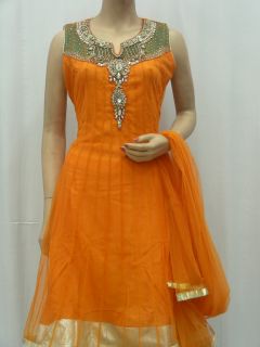 This Orange readymade net churidar kameez is adorned with beads