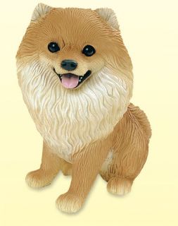 This handcrafted and exquisitely detailed Pomeranian dog figurine