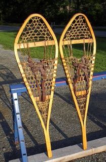  GROS LOUIS SNOWSHOES. The snowshoes have brown leather bindingsThe
