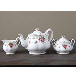Royal Albert New Country Rose White 3 piece Tea Set (Fine bone chinaPattern FloralCare instructions Hand washTeapot 10 inches long x 4.5 inches wide x 6 inches highCovered sugar 5 inches long x 3 inches wide x 5 inches highCreamer 5 inches long x 3 i